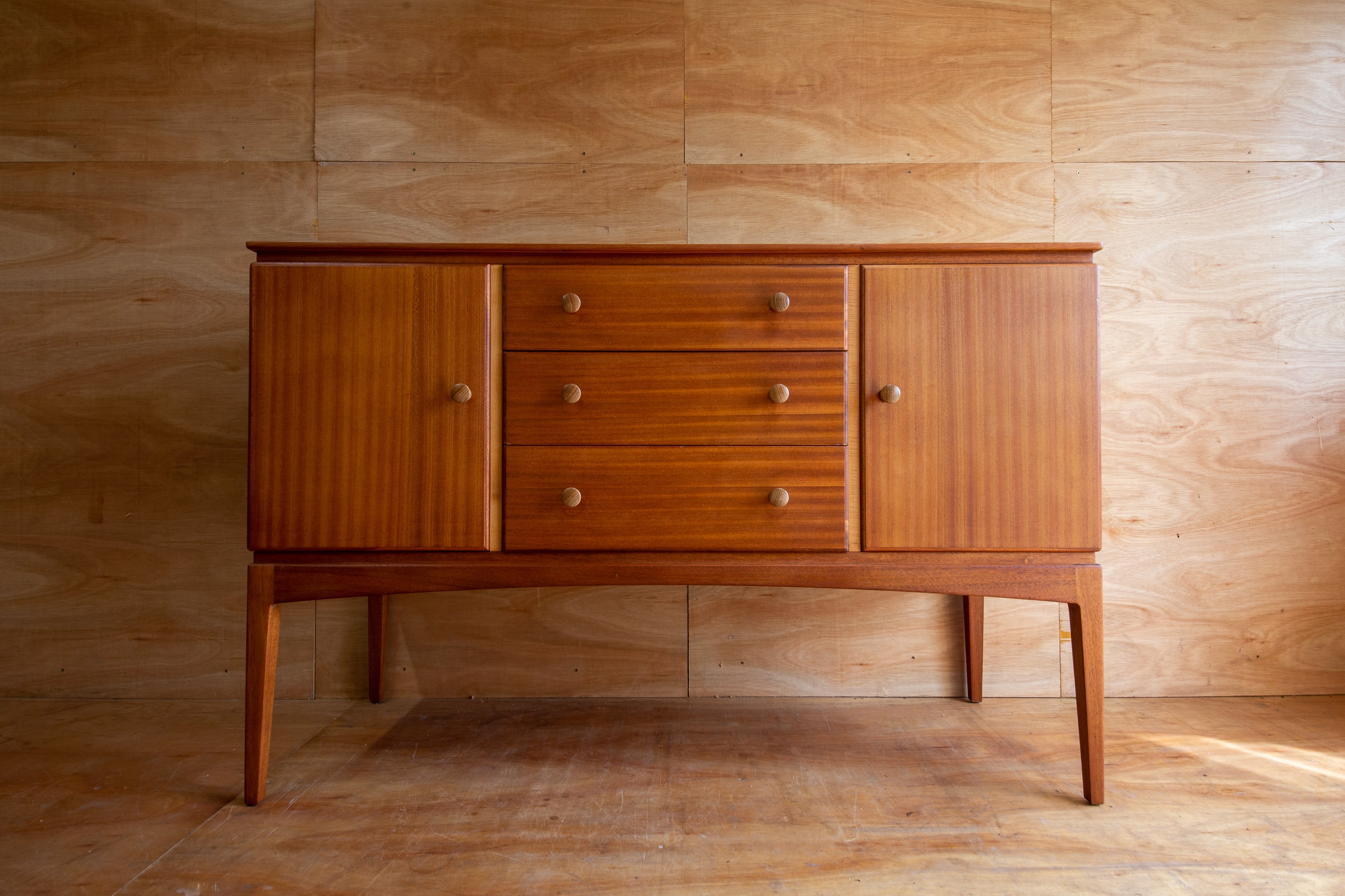 Wooden sideboard against a wooden wall